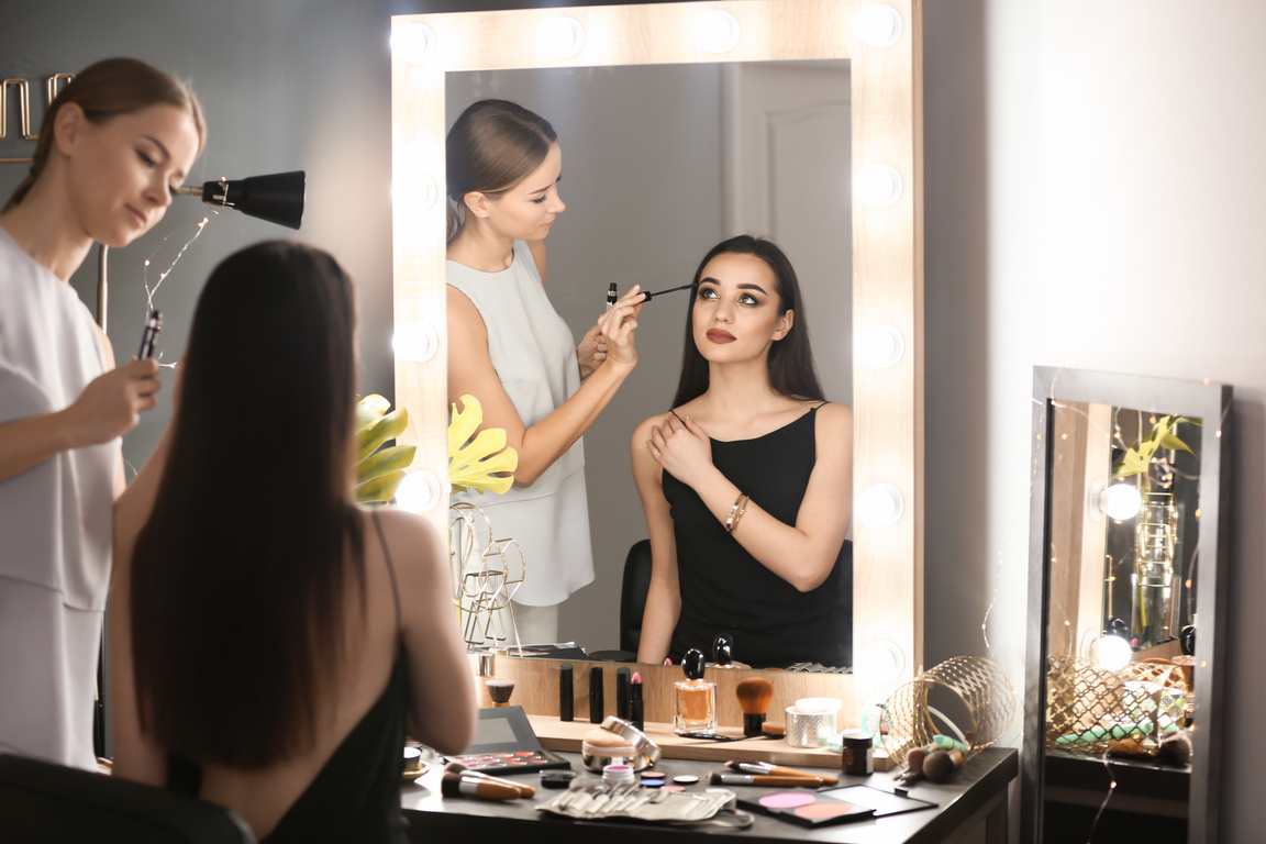 Professional Visage Artist Applying Makeup on Woman's Face in Salon